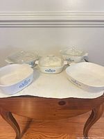 Front view of entire five-piece Cornflower Blue set showing three lidded casseroles and two open baking dishes