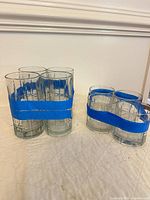 Group of all eight glasses taped into sets showing size difference