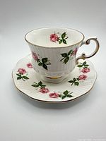 Full view of teacup seated on saucer displaying pattern and form