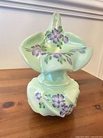 Full view of epergne showing trumpet in base, floral painting, color and shape