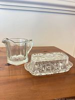 Butter dish lid and creamer side by side