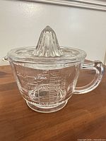 side view showing handle, spout and measurement markings