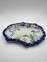 full view of scalloped porcelain trinket dish
