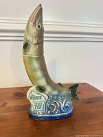 Full view of muskie fish decanter showing shape, glaze colors and Wisconsin State Fish plaque