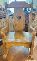 Front view showing seat, backrest heart cutout, wood grain