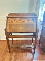 Front view of wooden drop-front desk closed