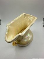 Top angle showing oval mouth and iridescent interior glaze