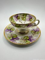 teacup resting on matching saucer showing full pattern