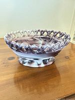 Side view showing marbled glass, lattice rim and pedestal base