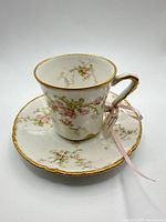 Cup on saucer showing overall design and gold trim