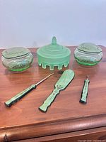 full set showing two covered dishes, frosted jar, three tools