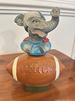 Full view ceramic football decanter with elephant stopper
