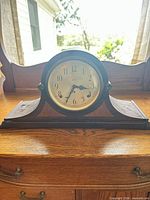 Front view of Ward wooden mantel clock on dresser
