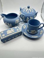 Overall view of teapot, sugar bowl, creamer, cup, saucer, and trinket box