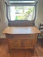 front view of wooden cabinet showing drawers, door, backboard