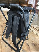 Rear view showing adjustable straps and tubular metal frame