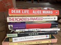 Stack of seven books showing spines and titles