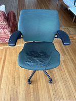 Front view of chair showing upholstery and armrests