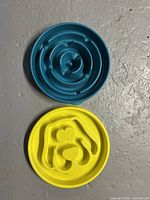 Both slow feeder bowls, blue and yellow, top view