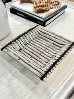 angled view showing square plate with bamboo relief and black banding
