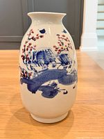 Full front view of vase showing primary landscape painting