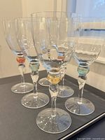 Front angled view of all six glasses showing coloured spheres and clear bowls