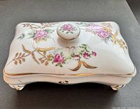Top view showing full floral pattern, knob, gold accents