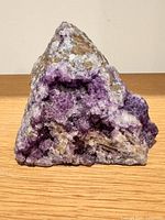 Front view showing purple crystal cluster and overall shape