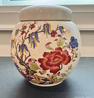 Front view of glazed ceramic ginger jar showing Bird of Paradise floral design