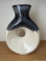 Front view of ceramic vase showing two-tone glaze and central opening