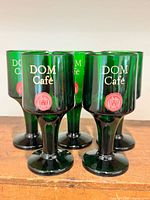 All five emerald green DOM Café glasses grouped