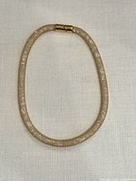 Full view of gold Stardust mesh wrap bracelet/necklace