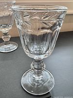 Front view of two cut glass goblets showing bowl pattern and ringed stem