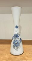 Full view of frosted white glass bud vase with blue floral design