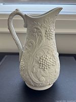 Right side view showing grapevine relief and handle