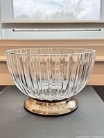 Side profile of ribbed crystal bowl on metal pedestal