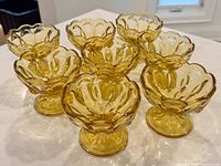 Group view of all eight amber footed sherbet bowls
