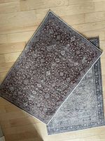 Both rugs overlapped showing colors and patterns
