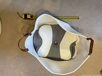 Basket top view showing interior, handles, and tape measure for width
