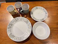Group view of patterned plates, bowls and pastel mugs