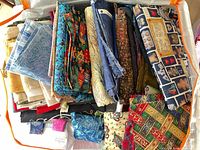 Top view of full tote showing variety of folded cotton fabrics and apron