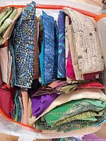 Bin of assorted fabric pieces folded