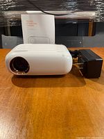 projector front view with lens and booklet