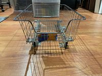 Front view of metal wire basket with sliding rail hardware