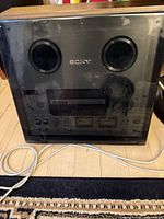 Tapecorder with dust cover in place, power cord visible