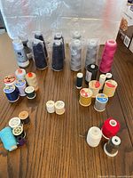 Full lot overview showing cones and spools grouped on table