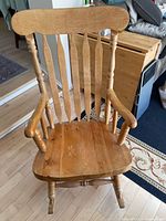 front view of spindle-back solid wood rocking chair