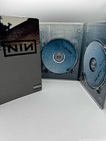 Gatefold open showing both blue DVDs seated in clear trays