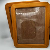 Front view of both teak frames showing wood grain and rounded edges
