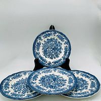 Front view of one plate on stand with others arranged below